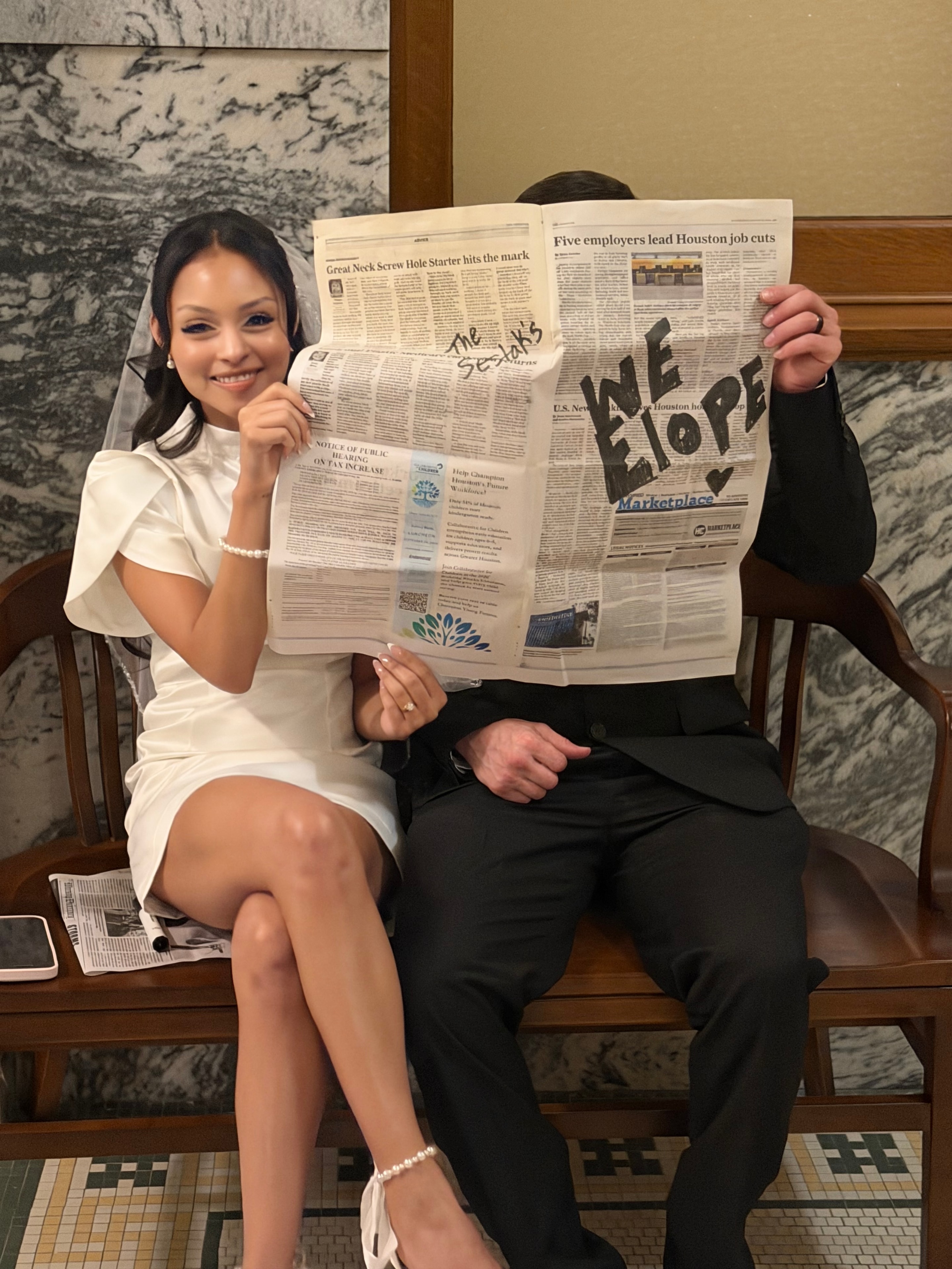 Bride holding "We Elope" newspaper — intimate elopement in Houston, TX